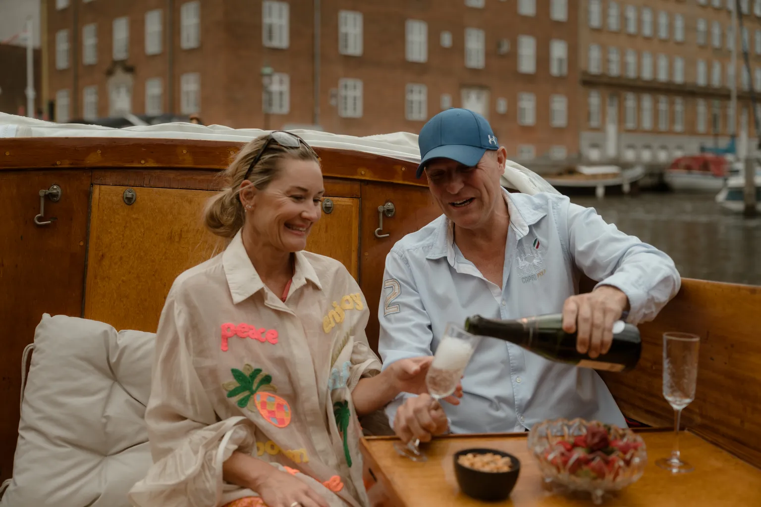 Michael pouring champagne for a couple on the boat