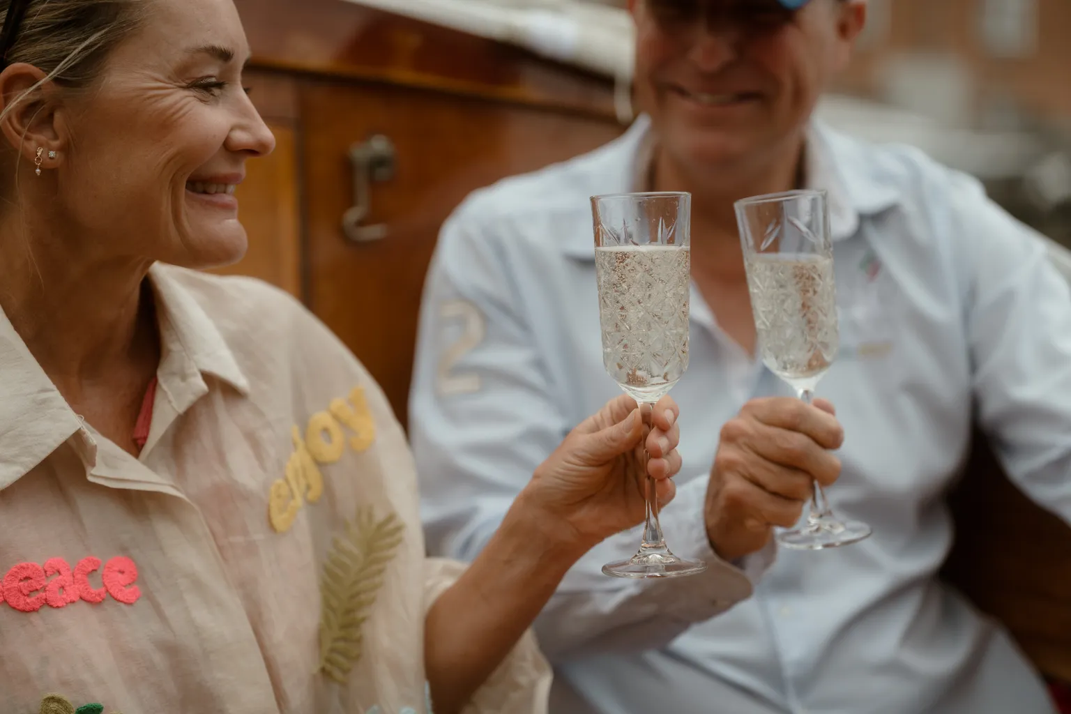 A couple toasting with champagne on the boat